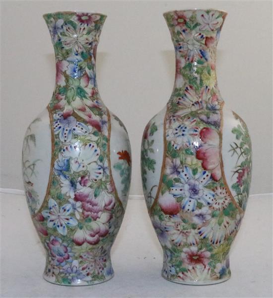 A pair of Chinese famille rose millefleur bottle vases, early 20th century, 24.5cm